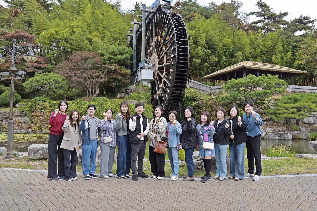 Members of Gyeongju's 16th SNS Promoter cohort and city public relations staff pose for a photo during a field familiarization tour Wednesday aimed at developing tourism promotional content. [Gyeongju City]