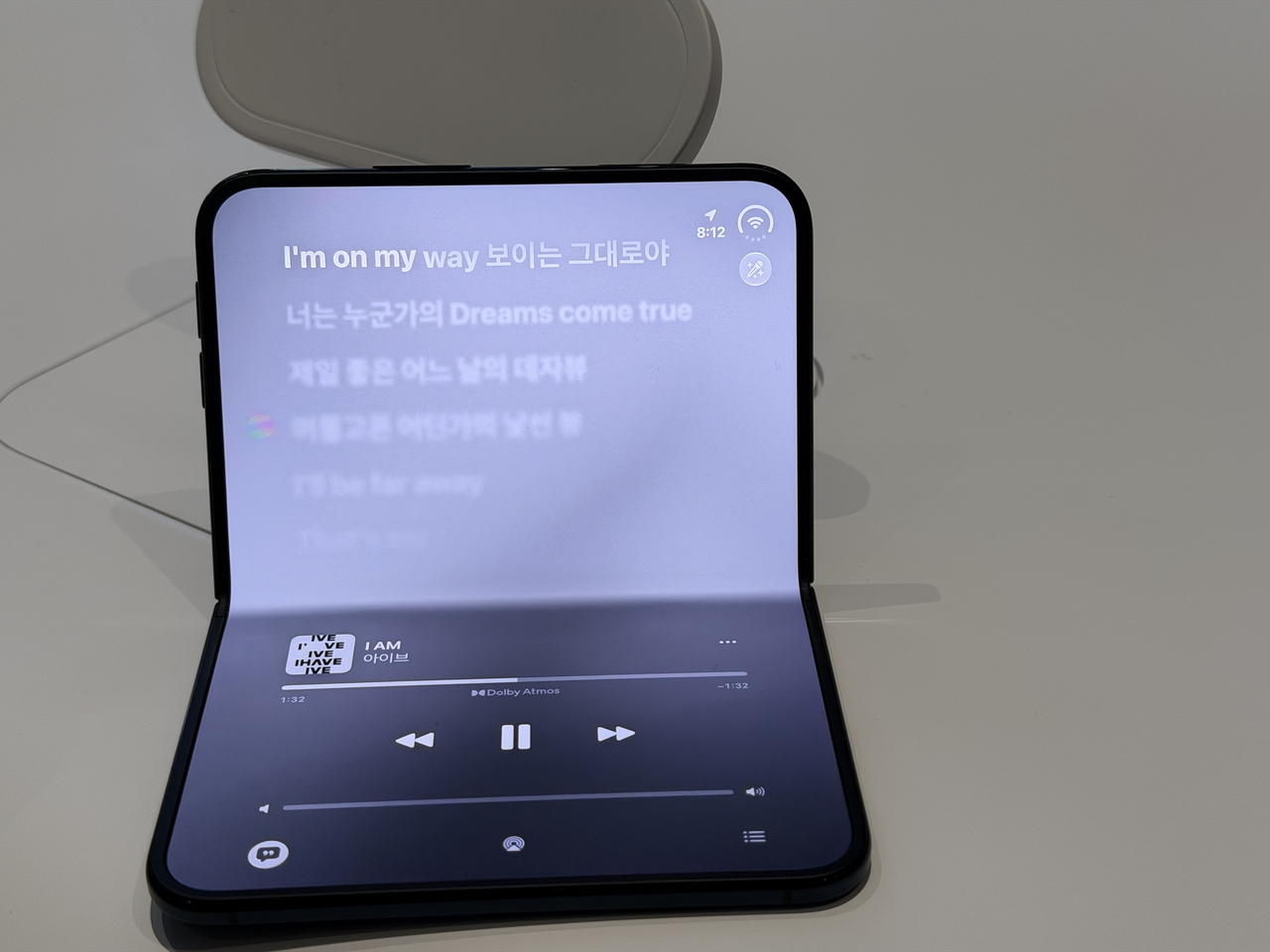Apple Music displays lyrics on the upper half of the iPhone Duo's folding screen and playback controls below during a hands-on demonstration at Apple Myeongdong in central Seoul on Friday. (Moon Joon-hyun/The Korea Herald)