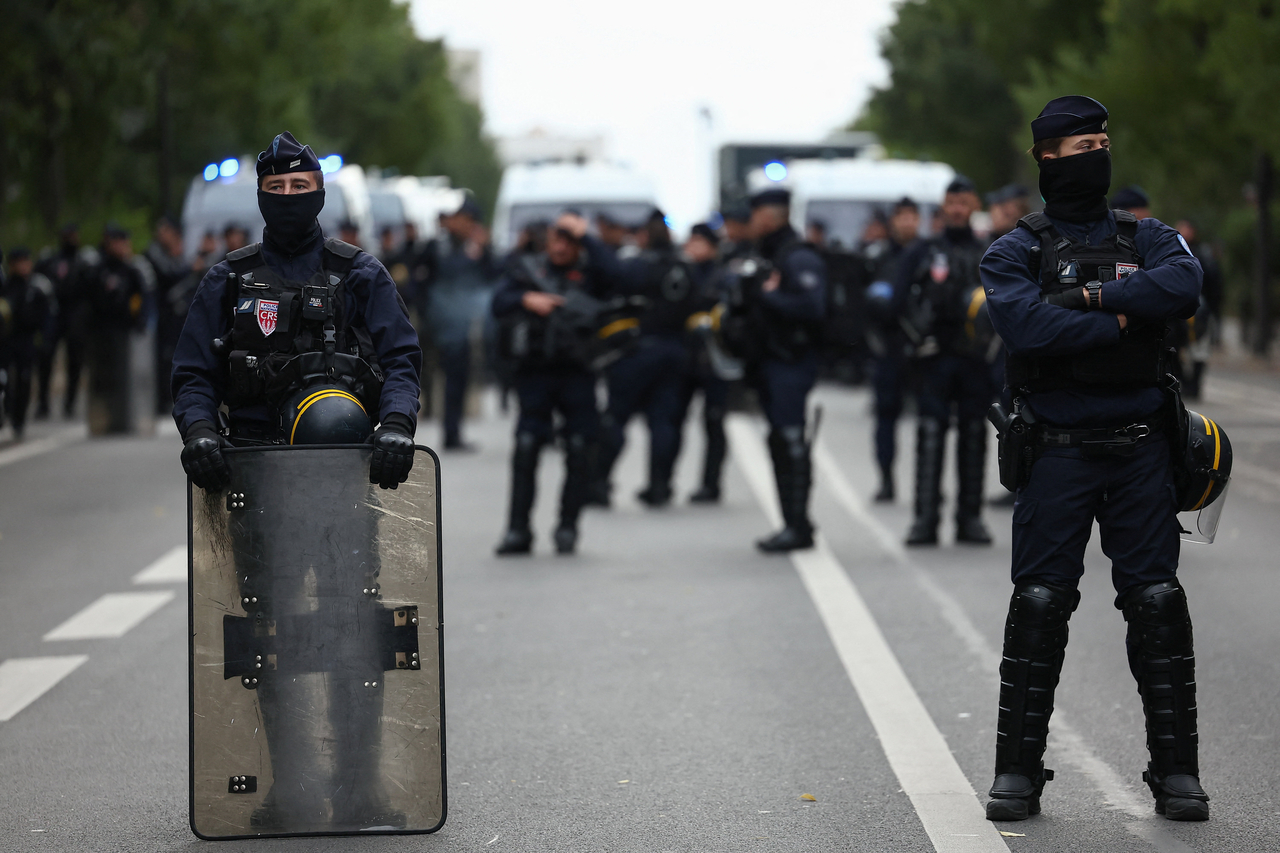 French CRS riot police stand guard during a demonstration organized by student groups and trade unions in Paris on Thursday. [Reuters]