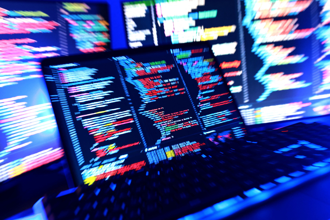 A keyboard and screens running computer code are displayed in this illustration taken on Oct. 22, 2026. (Reuters-Yonhap)