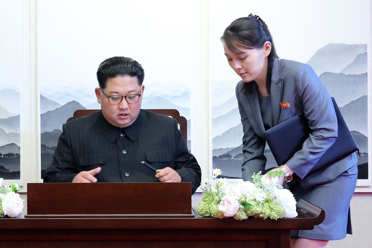 North Korea's leader Kim Jong Un signs the guest book next to his sister Kim Yo Jong during the Inter-Korean summit with South Korea's President Moon Jae-in at the Peace House building on the southern side of the truce village of Panmunjom on April 27, 2018. (AFP-Yonhap)