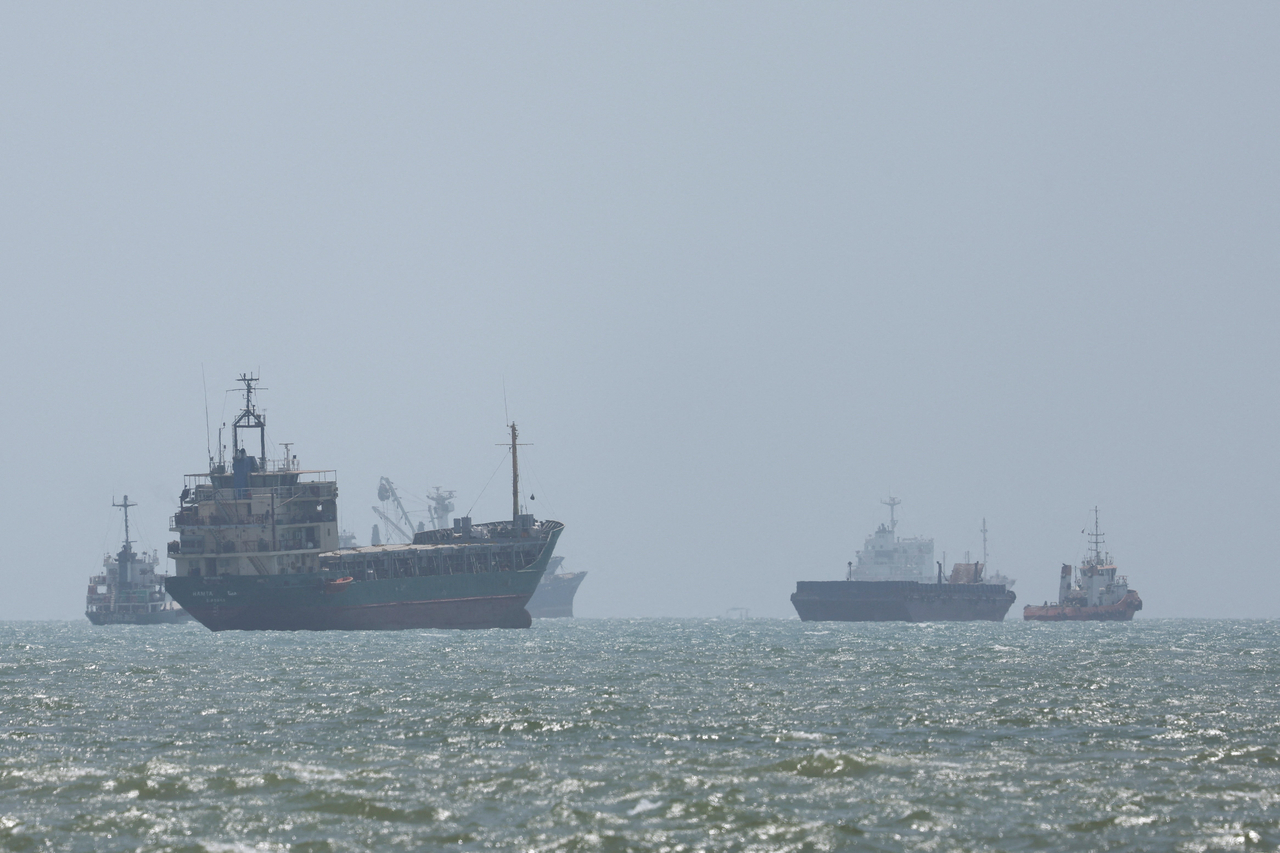 Vessels in the Strait of Hormuz are visible near the beach of Bandar Abbas, Iran, Aug. 25.   Reuters-Yonhap