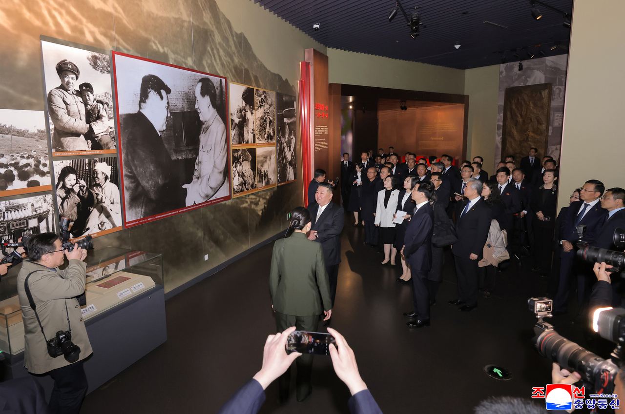 North Korean leader Kim Jong-un and his delegation view an exhibit at the Memorial Hall of the War to Resist US Aggression and Aid Korea in Dandong, Liaoning province, on Oct. 24. (KCNA)