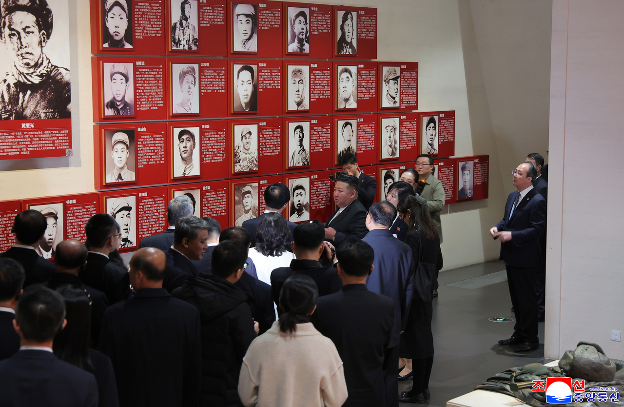 North Korean leader Kim Jong-un and his delegation view an exhibit at the Memorial Hall of the War to Resist US Aggression and Aid Korea in Dandong, Liaoning province, on Oct. 24. (KCNA)