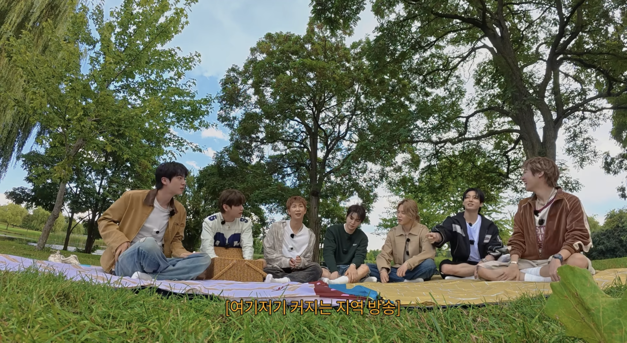 BTS is seen enjoying a picnic in Toronto during an episode of "Run BTS 2.0," released on Oct. 6. (@BTS, YouTube)