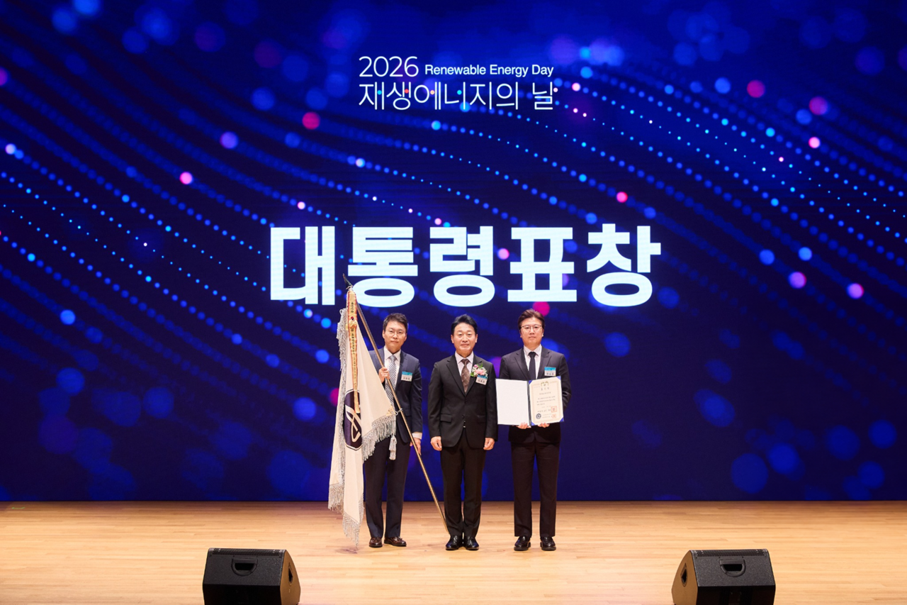 At the "2026 Renewable Energy Day" ceremony held at COEX in Seoul on Friday, Lee Hyeon-hui (from left), head of Amorepacific's Sustainability Management Center, Second Vice Minister of the Ministry of Climate, Environment and Energy Lee Ho-hyeon, and Kwon Soon-cheol, executive vice president of Amorepacific's Safety and Environment Division, pose for a photo after receiving a presidential commendation. [Amorepacific]