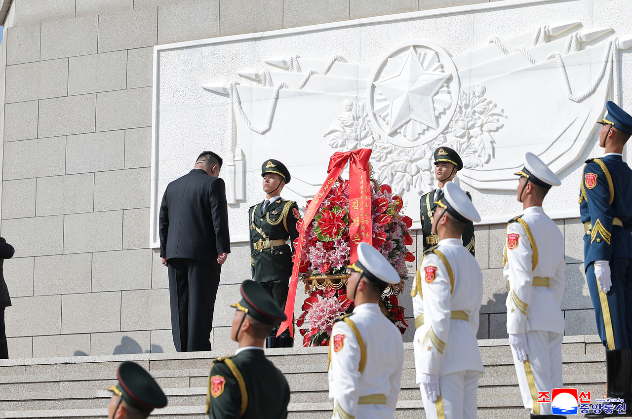 North Korean leader Kim Jong-un (L) visits the Chinese city of Dandong on Saturday, ahead of the anniversary of China's entry into the 1950-53 Korean War, reaffirming the two countries' blood-forged ties and vowing to advance their friendship, in this photo released by the North's official Korean Central News Agency the following day. (Yonhap)