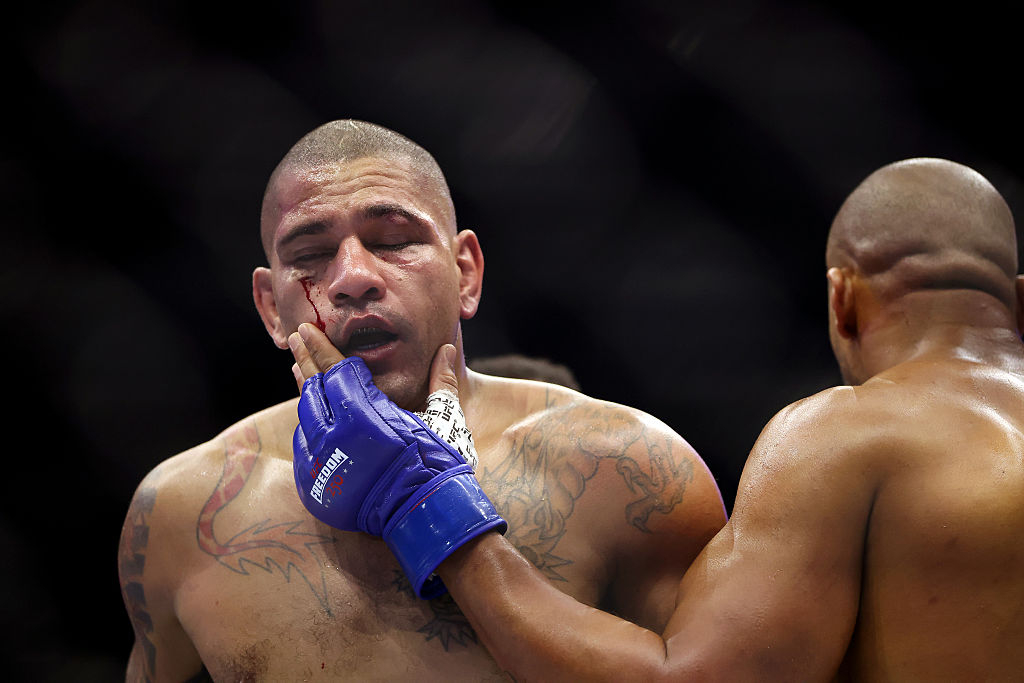 Alex Pereira (left) walks back to his corner after the first round of his bout against Ciryl Gane at UFC Freedom 250 at the White House in June. Gane, who opened a cut on Pereira's face, appears relaxed as he strokes his opponent's cheek, while a visibly shaken Pereira looks dazed. [Getty Images]