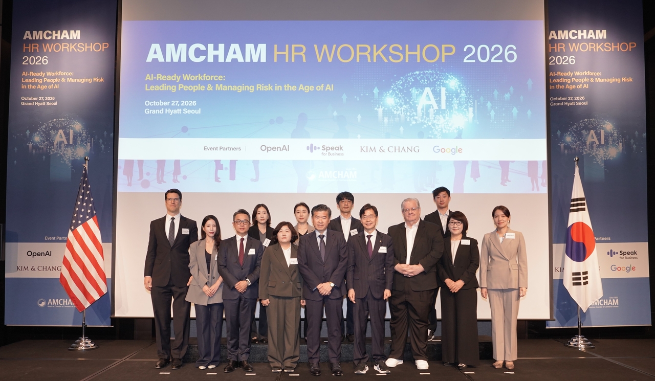 Lee Sang-im (front row, fourth from left), director of the Ministry of Employment and Labor's Vocational Skills Policy Division, AmCham Chairman and CEO James Kim (fifth from left) and Rep. Cho Kyoung-tae (sixth from left) pose with other participants at AmCham's HR Workshop 2026 at the Grand Hyatt Seoul on Tuesday. (AmCham)