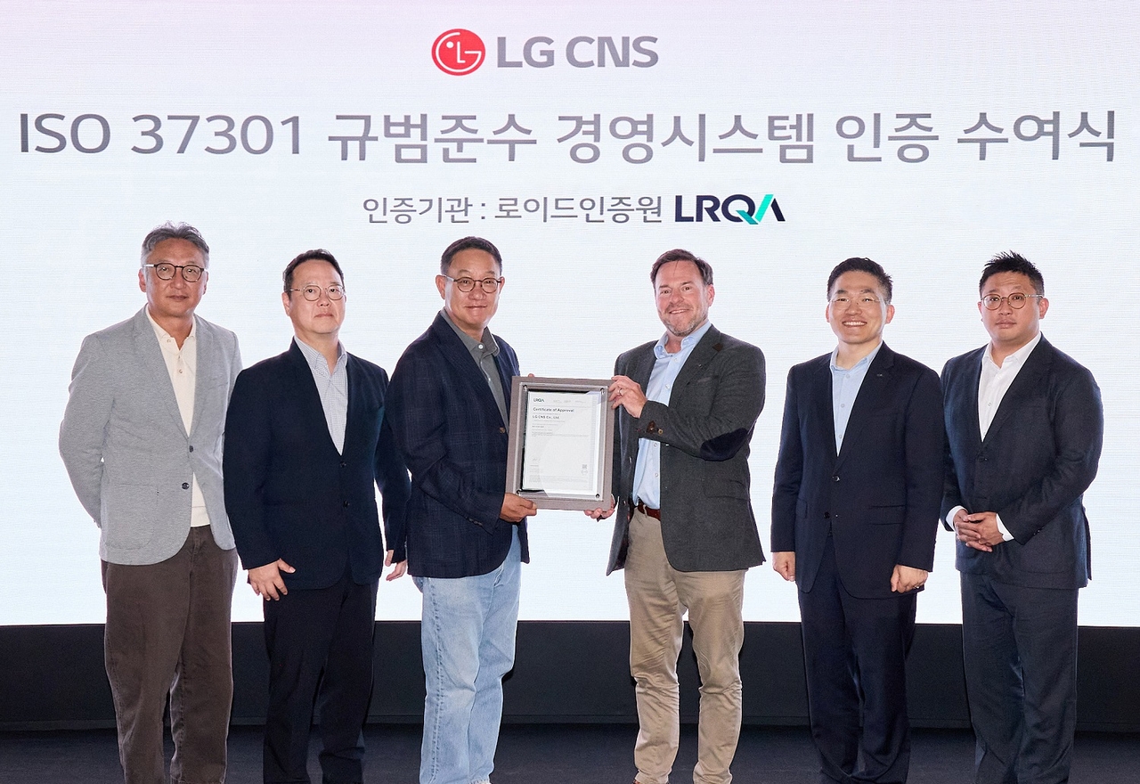 LG CNS CEO Hyun Shin-kyun (third from left) and LRQA Global Commercial Advisor Stuart Kelly (third from right) pose with officials at the certification ceremony. [LG CNS]