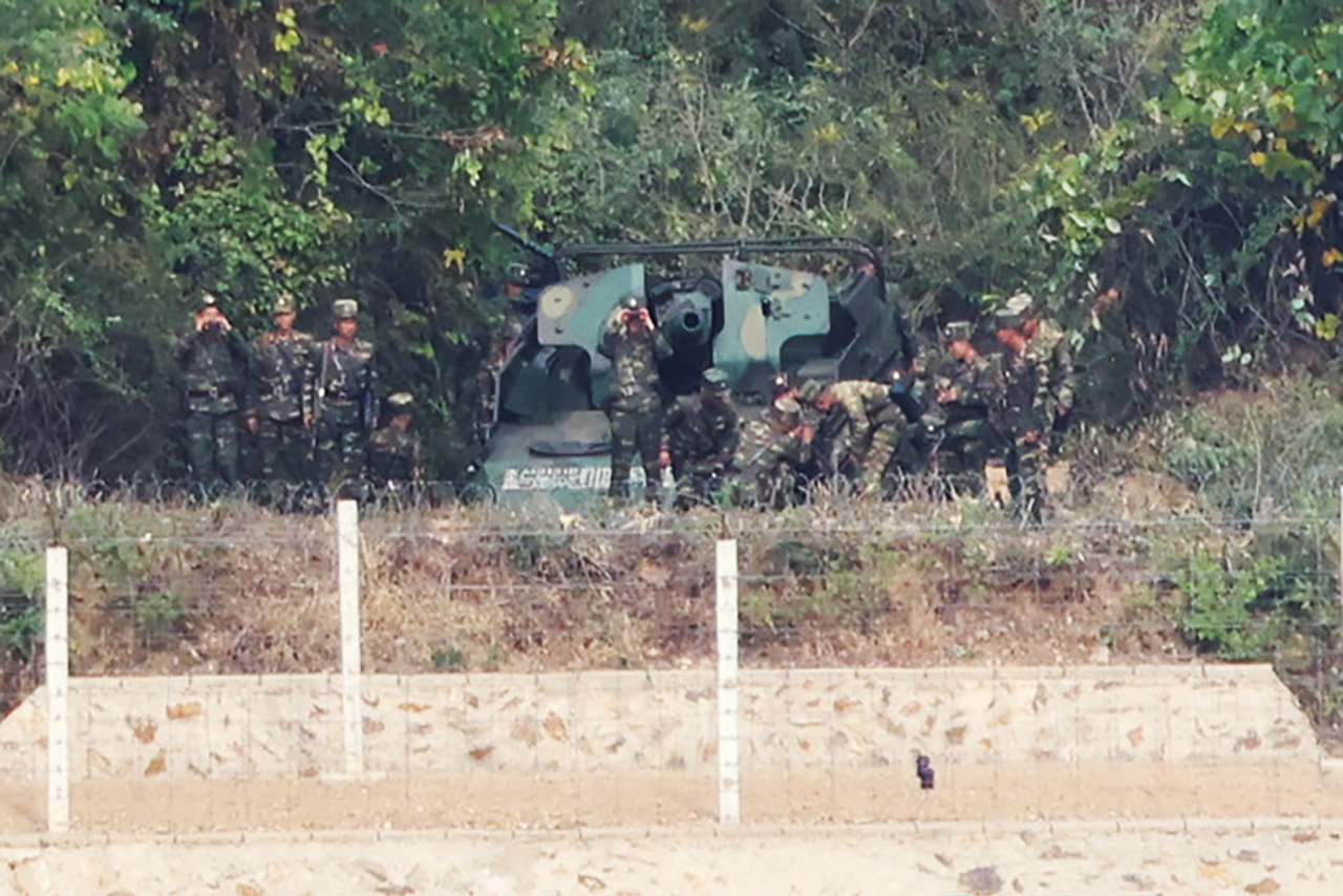 North Korean soldiers observe the South from a self-propelled artillery position in a coastal border area of Kaepung County, North Hwanghae Province, as seen from Aegibong Observatory in Gimpo, Gyeonggi Province, Monday. (Yonhap)
