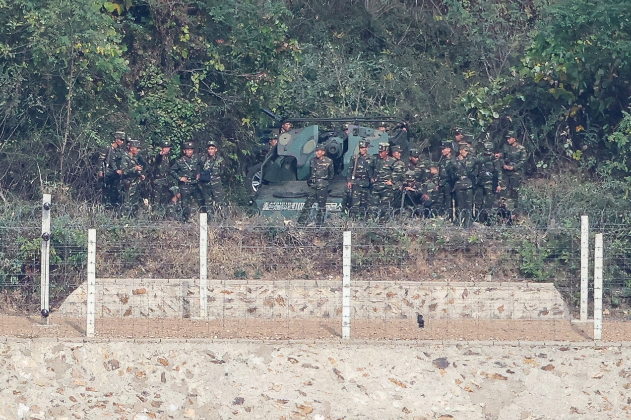 North Korean soldiers gather around self-propelled gun emplacements along the border area of Gaepung County, Hwanghae Province, as seen from the Aegibong Observatory in Gimpo, Gyeonggi Province, on Monday, amid heightened inter-Korean tensions following North Korea's announcement of plans to bolster firepower along the MDL. [Yonhap]