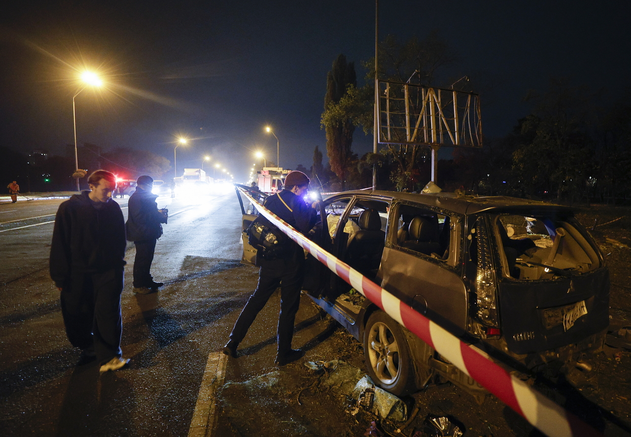 People view the site of a Russian missile strike on a road in a residential area in Kyiv, Ukraine, Tuesday. (EPA-Yonhap)