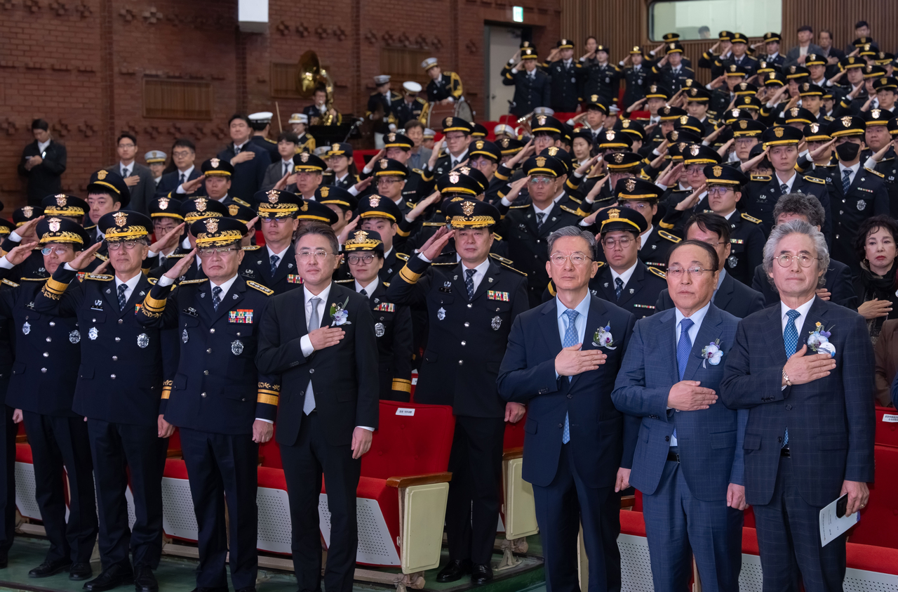 Participants of the 81st Corrections Day ceremony, including acting Justice Minister Lee Jin-soo (front row, fourth from left) and former Justice Minister Rep. Jung Sung-ho (front row, third from right), salute the national flag at the Government Complex Gwacheon on Wednesday. (Ministry of Justice)