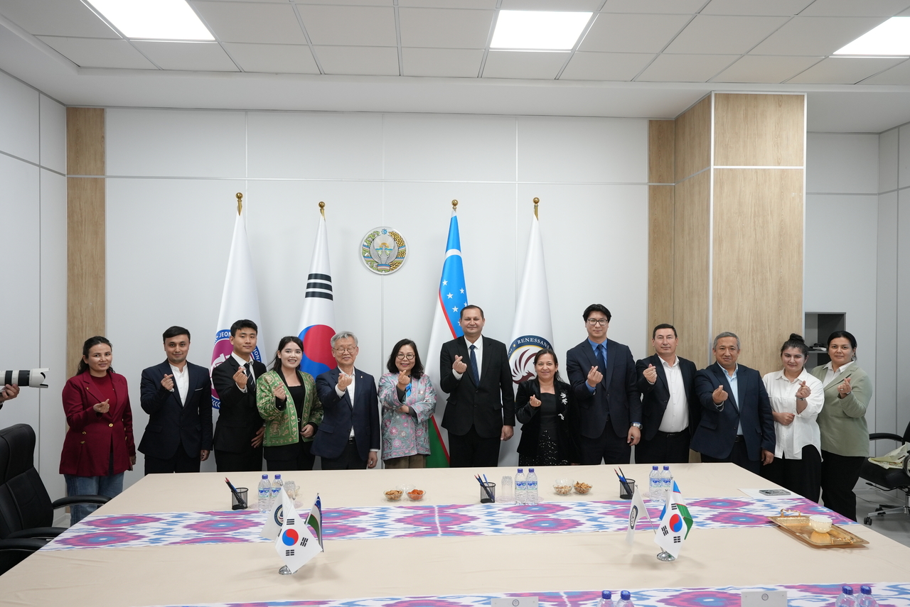 Officials from Jeonbuk National University, including head of international affairs Cho Hwa-rim (sixth from right) and Rensaissance University officials pose for a photo on Oct. 23 after the opening ceremony of the JBNU International Center in Tashkent, Uzbekistan. (JBNU)