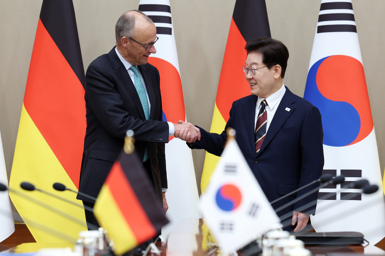 President Lee Jae Myung shakes hands with German Chancellor Friedrich Merz ahead of their expanded summit at Cheong Wa Dae in Seoul on Thursday. (Yonhap)