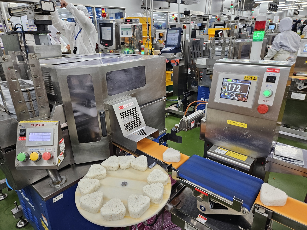 Triangle kimbap is manufactured at BGF Foods' food center in Jincheon, North Chungcheong Province, on Wednesday. [BGF Retail]