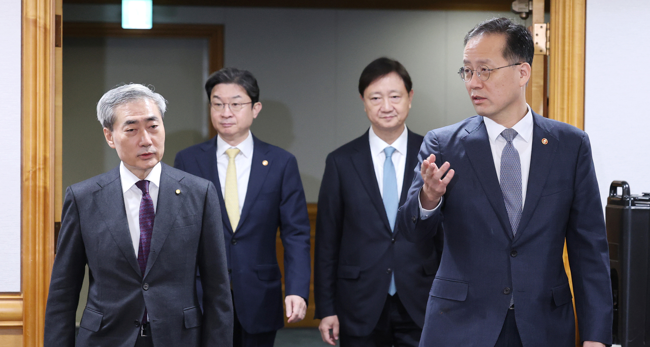 Finance Minister Lee Hyoung-il (R) enters the venue of a meeting held in Seoul with Bank of Korea Gov. Shin Hyun-song (L), Financial Services Commission Chairman Lee Eog-weon (2nd from L) and Financial Supervisory Service Gov. Lee Chan-jin on Thursday. (Yonhap)