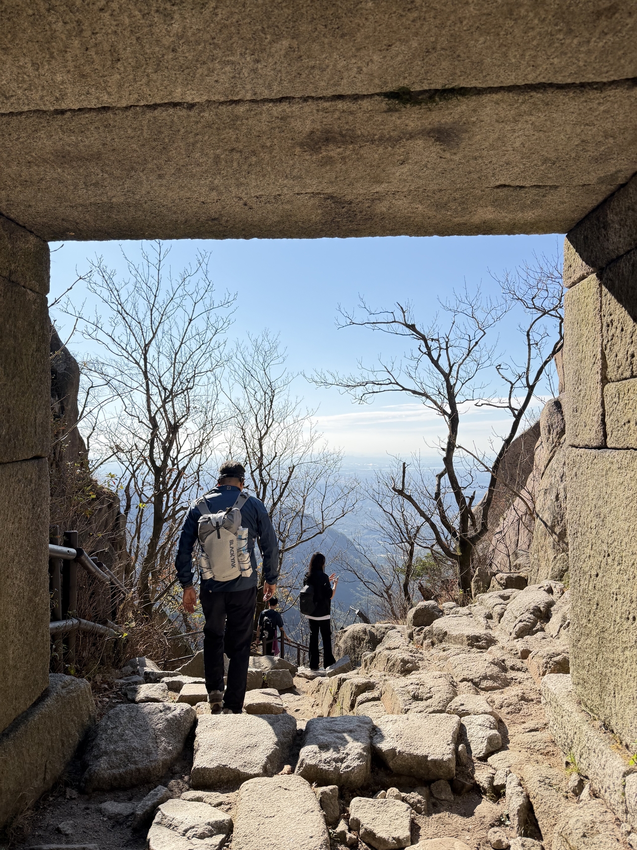 Hikers pass through Baegunbongammun, a stone gate on the route to Baegundae peak, on Oct. 23. (Hong Yoo/The Korea Herald)