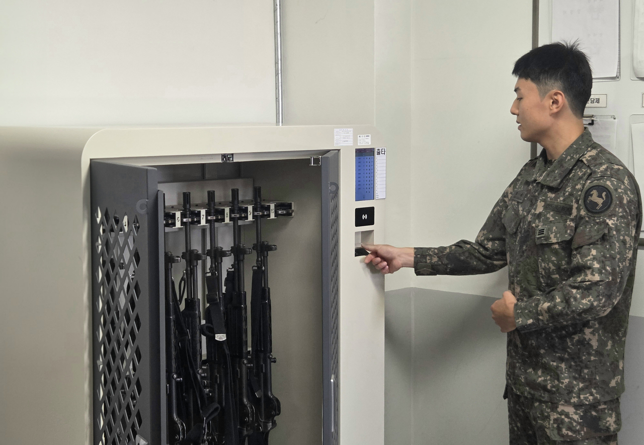 A soldier places a finger on a scanner to open a smart weapons rack at the 9th Infantry Division in Goyang, Gyeonggi Province, on Wednesday. (Republic of Korea Army)