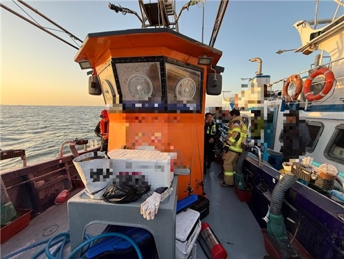South Korean Coast Guard officers rescue people aboard a fishing boat (Incheon Coast Guard Station)