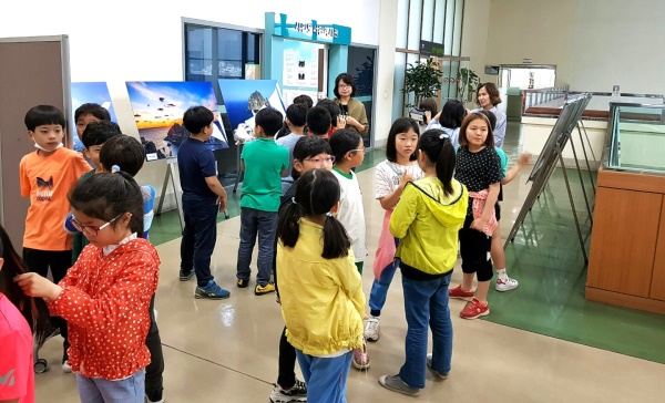 부산남명초등학교에서 열리고 있는  3차 독도사진 순회 전에서 학생들이 생생한 독도사진을 감상하며  독도  VR체험존에 즐거워 하고 있다.(사진=울릉군 제공)
