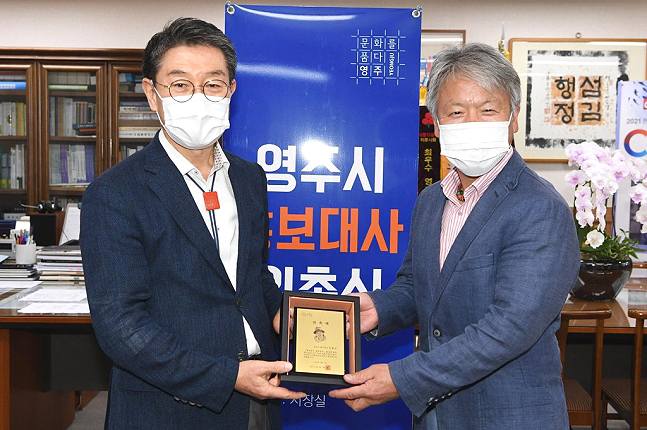 장욱현 영주시장이 엄홍길(오른쪽) 산악대장에게 홍보대사 위촉패를 전달하고 있다. (영주시 제공 )