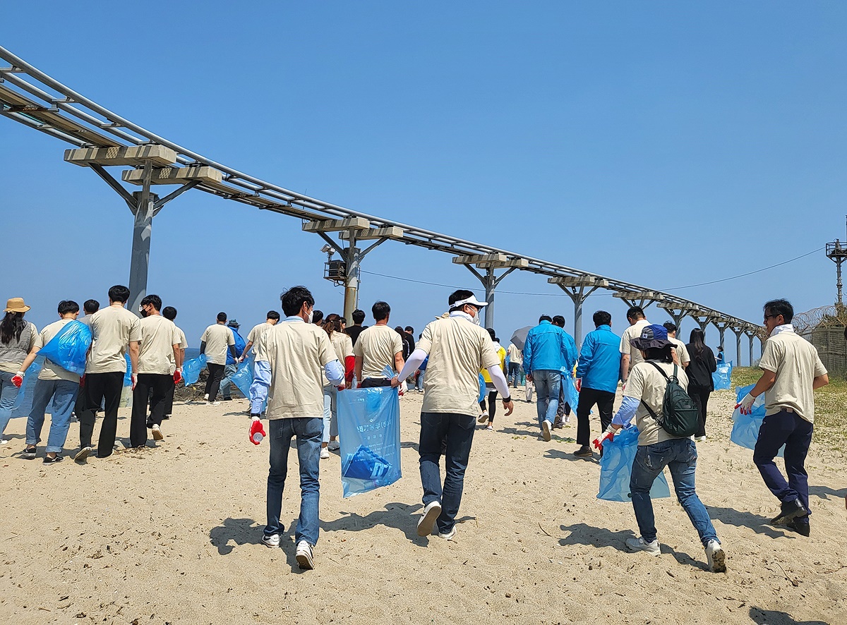 볼런투어 참여한 국제로타리 3620지구 회원들이 울진 관광을 즐긴 뒤 후정해수욕장에서 환경 정화활동을 펼치고 있다. (울진군 제공)